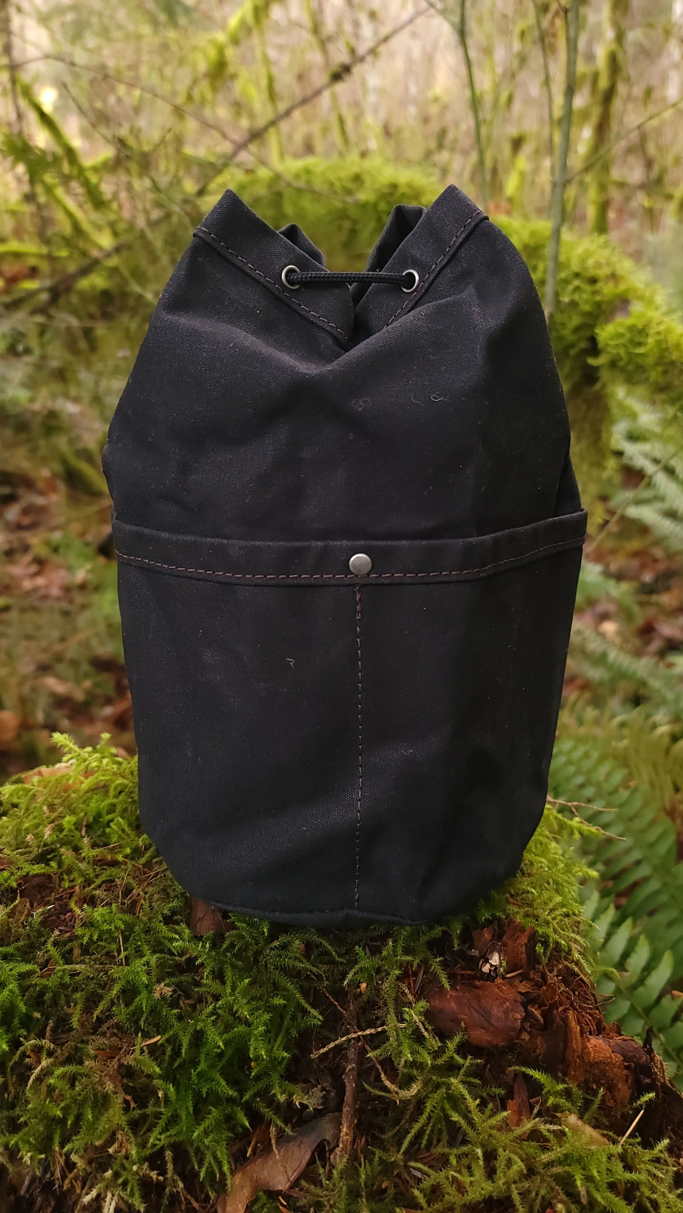 Black Waxed Canvas Cedar Bucket Bag with Outside Pockets.